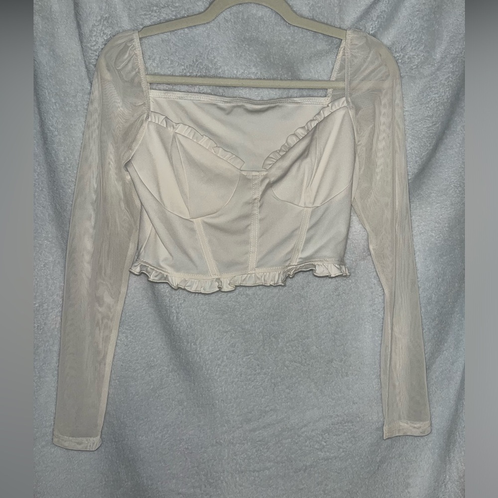 Loose corset eggshell colored top with sheer sleeves.